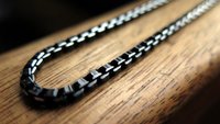 black necklace with silver edge. made in Canada.