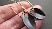 unique black dangle earring with gold earwires. modern anodized aluminum jewelry. splurge.