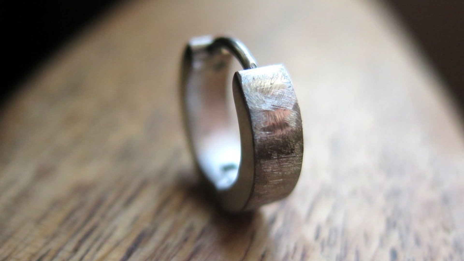 silver hoop earring for men. men's jewelry in brushed stainless steel.