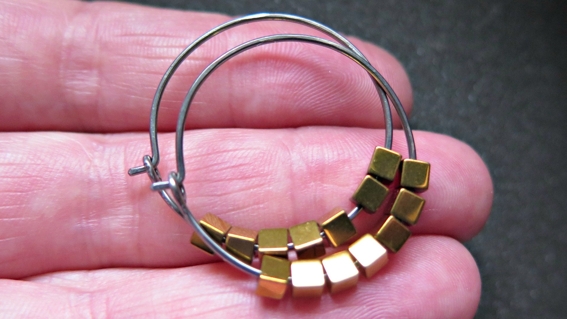 gold and silver earrings. hypoallergenic niobium hoops for sensitive ears.