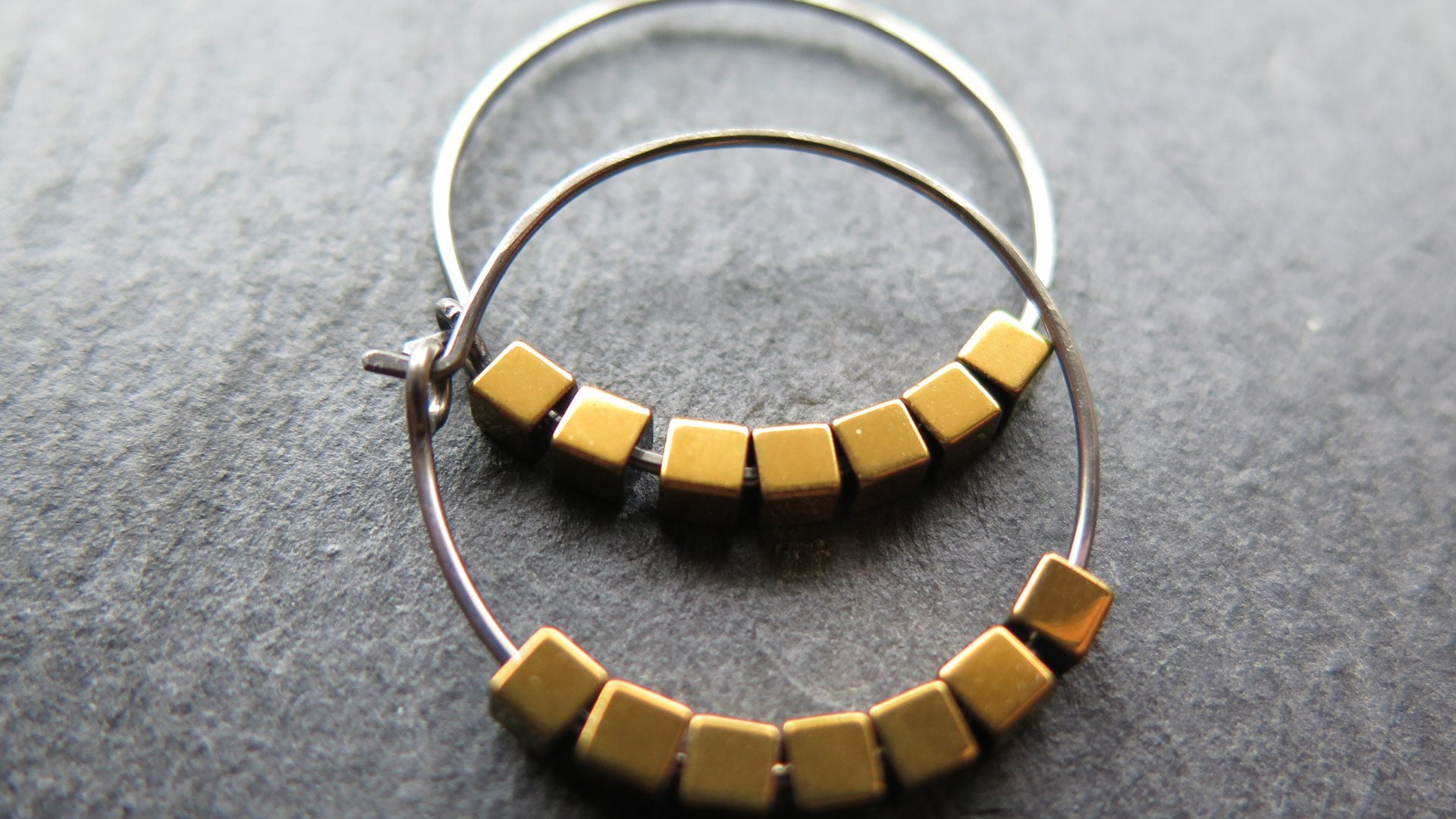 gold and silver earrings. hypoallergenic niobium hoops for sensitive ears.