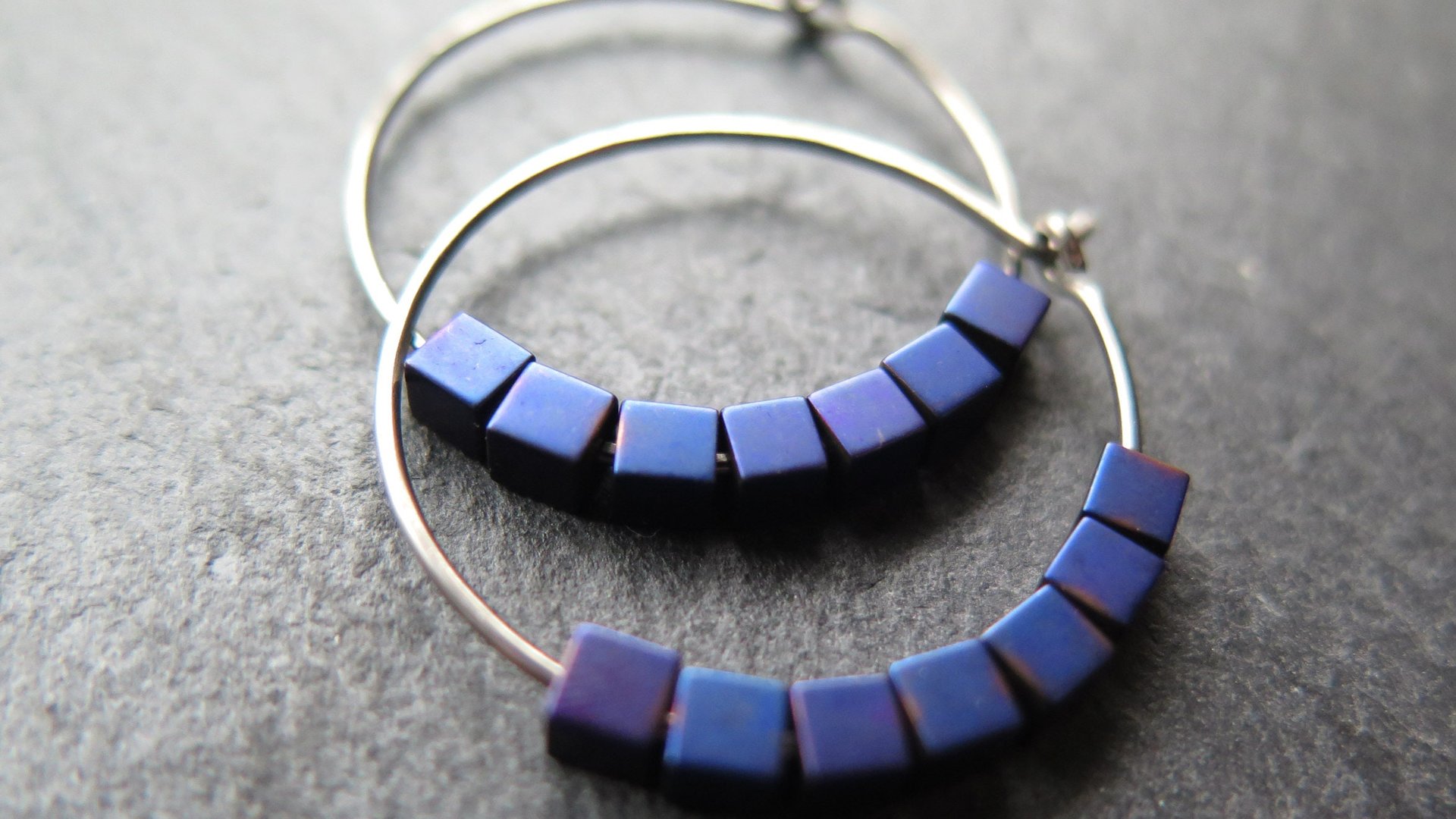 indigo earrings with hematite cubes. hypoallergenic niobium hoops for sensitive ears. modern purple blue jewelry.
