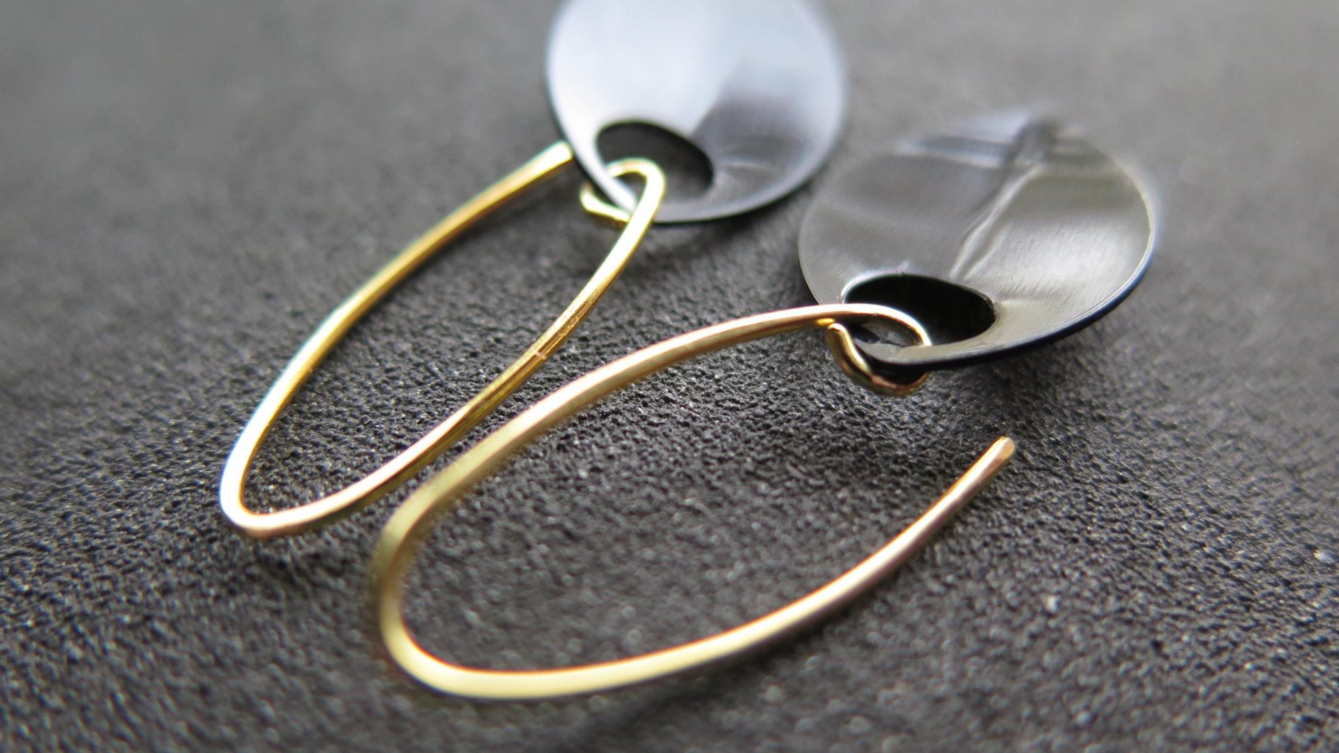 unique black dangle earring with gold earwires. modern anodized aluminum jewelry. splurge.